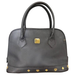Vintage MCM black bolide style bag with gold tone metal studded charms. Rare masterpiece purse for unisex use. Phenomenon
