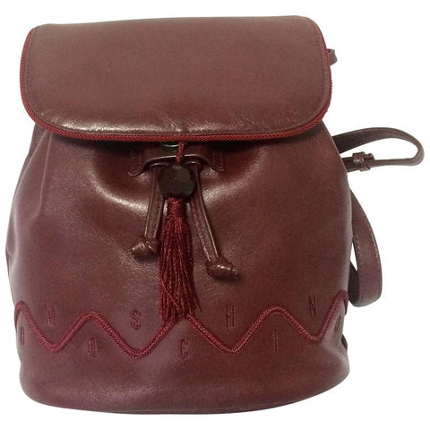 Vintage MOSCHINO genuine dark wine nappa leather backpack with tassel and logo embroidery motifs. Small to Medium size for daily use. 0704re