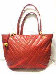 Vintage CHANEL red caviarskin v stitch, chevron style chain shoulder tote bag with golden CC ball charm. Classic purse for daily use.